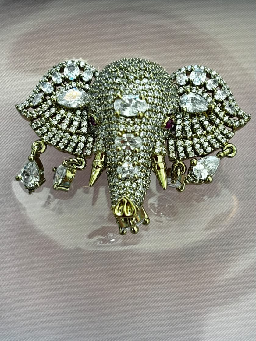 Crystal elephant head brooch in antique gold with white rhinestones and ruby accent stones