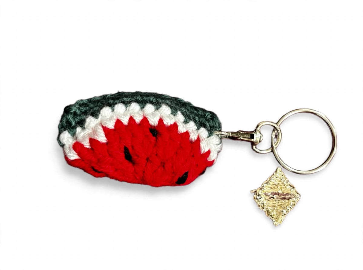 Crochet watermelon keychain close-up with gold diamond charm