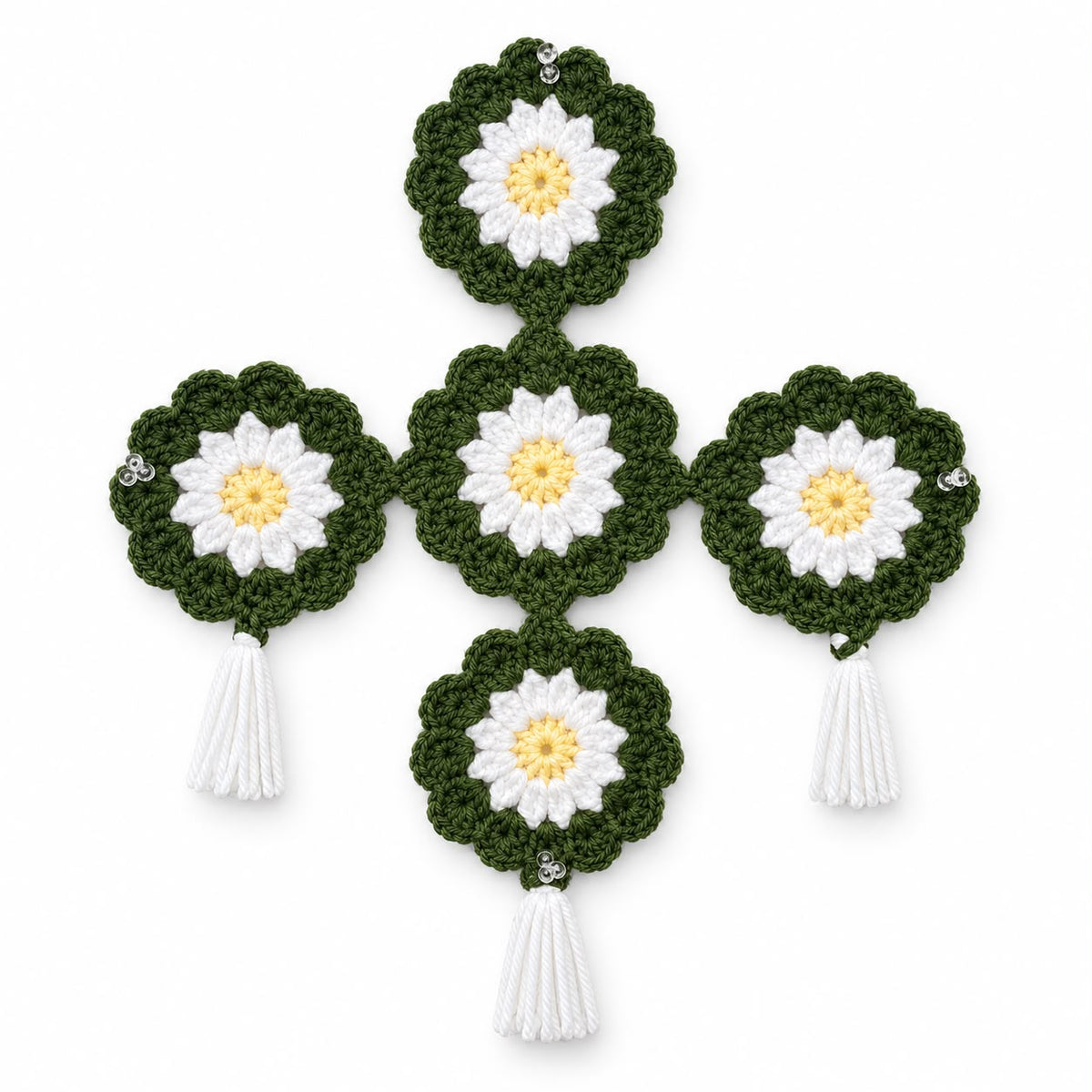 Handmade crochet daisy wall hanging in olive green with white petals and yellow centers, white tassels and crystal beads